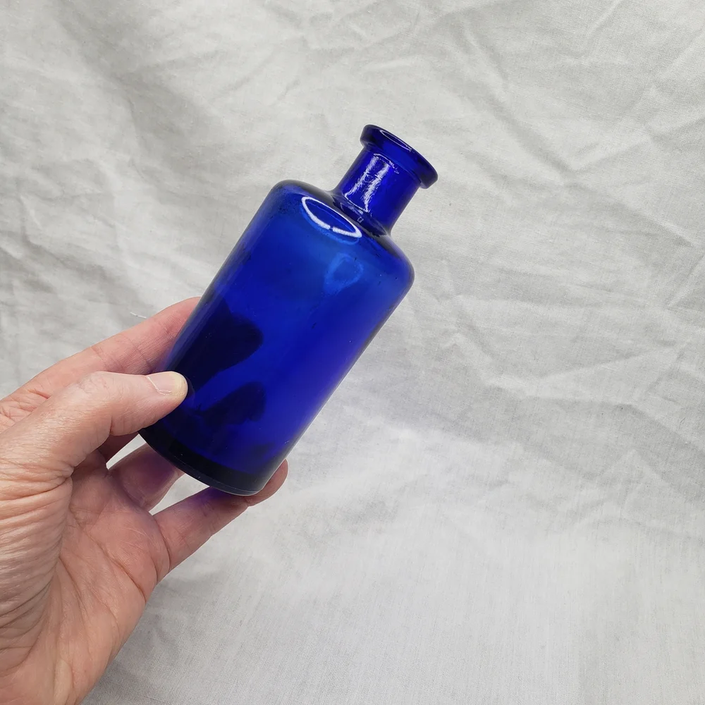 Wood Monstera Leaf Shelf With Blue Glass Vase